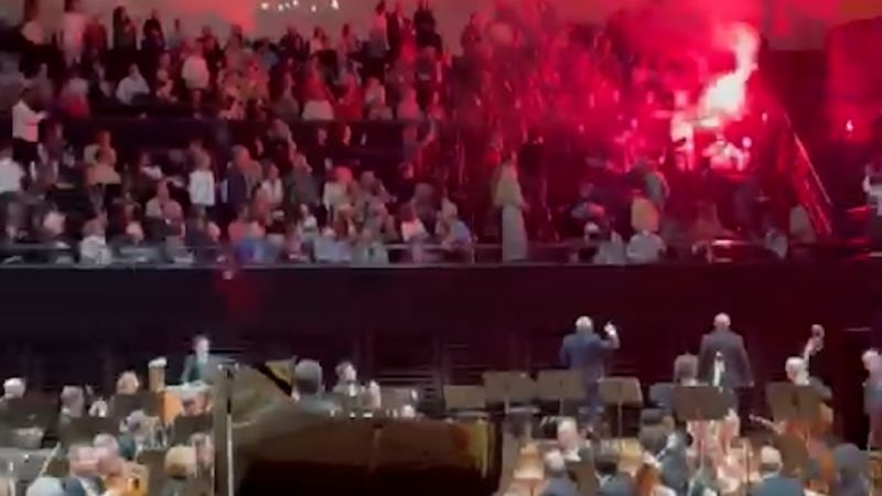 Protesters light flares at Israeli Orchestra concert