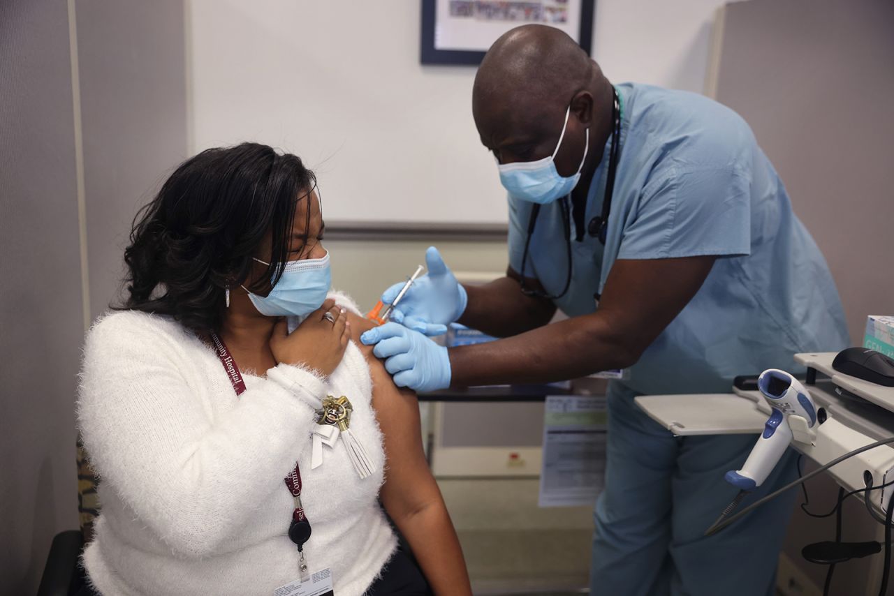 Christianna Tucker gets a Covid-19 vaccine from Anthony Oyetola at Roseland Community Hospital on December 18, in Chicago, Illinois.