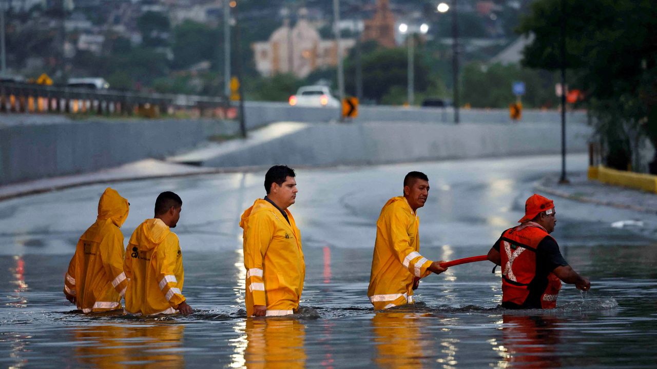 Government employees work to drain a flooded overpass as tropical storm Alberto continues to advance, in Monterrey, Mexico, on June 19.