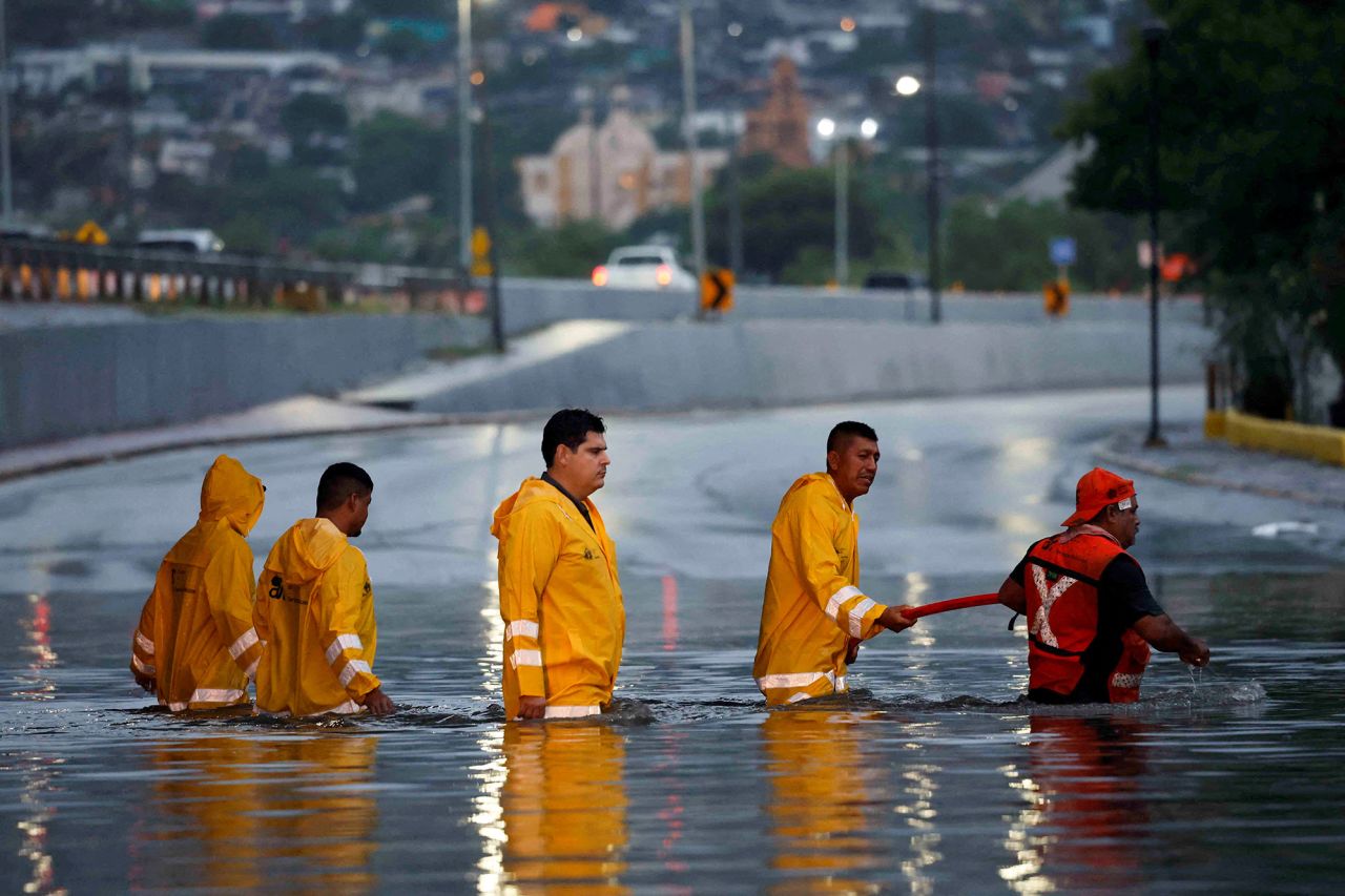 Government employees work to drain a flooded overpass as tropical storm Alberto continues to advance, in Monterrey, Mexico, on June 19.