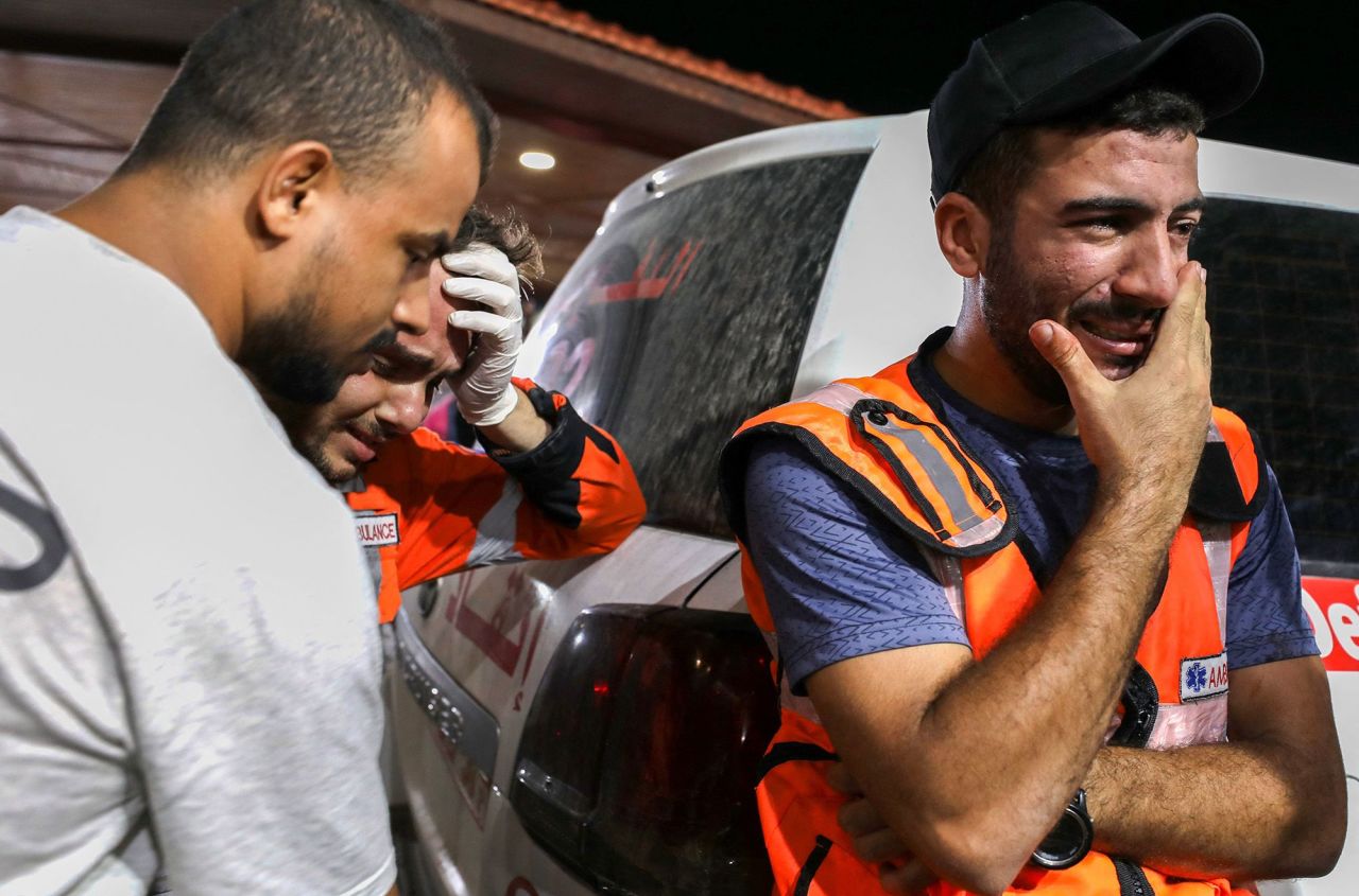 Palestinian paramedics cry outside Al-Shifa hopsital in Gaza City on October 16.