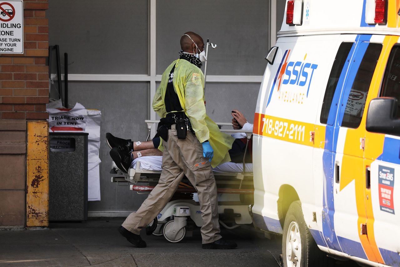 A medical workers takes in a patient at Maimonides Medical Center in Brooklyn, New York, on April 12.