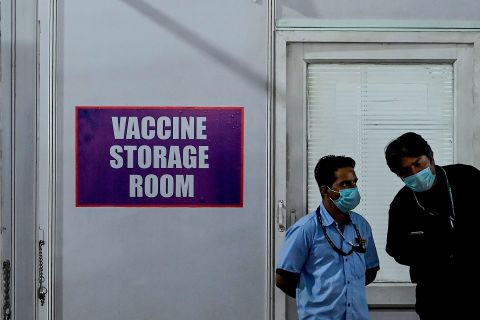 A staff member talks with security personnel outside of a storage room at a Covid-19 vaccination unit in Mumbai on January 7.