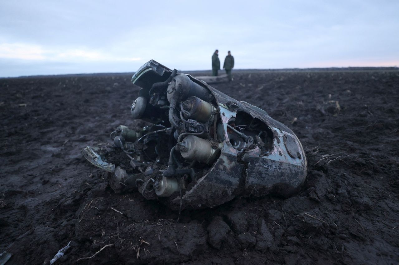Investigators gather near fragments of a munition downed by?Belarusian air defences outside the village of Harbacha in the Grodno region,?Belarus, on December 29, 2022. 