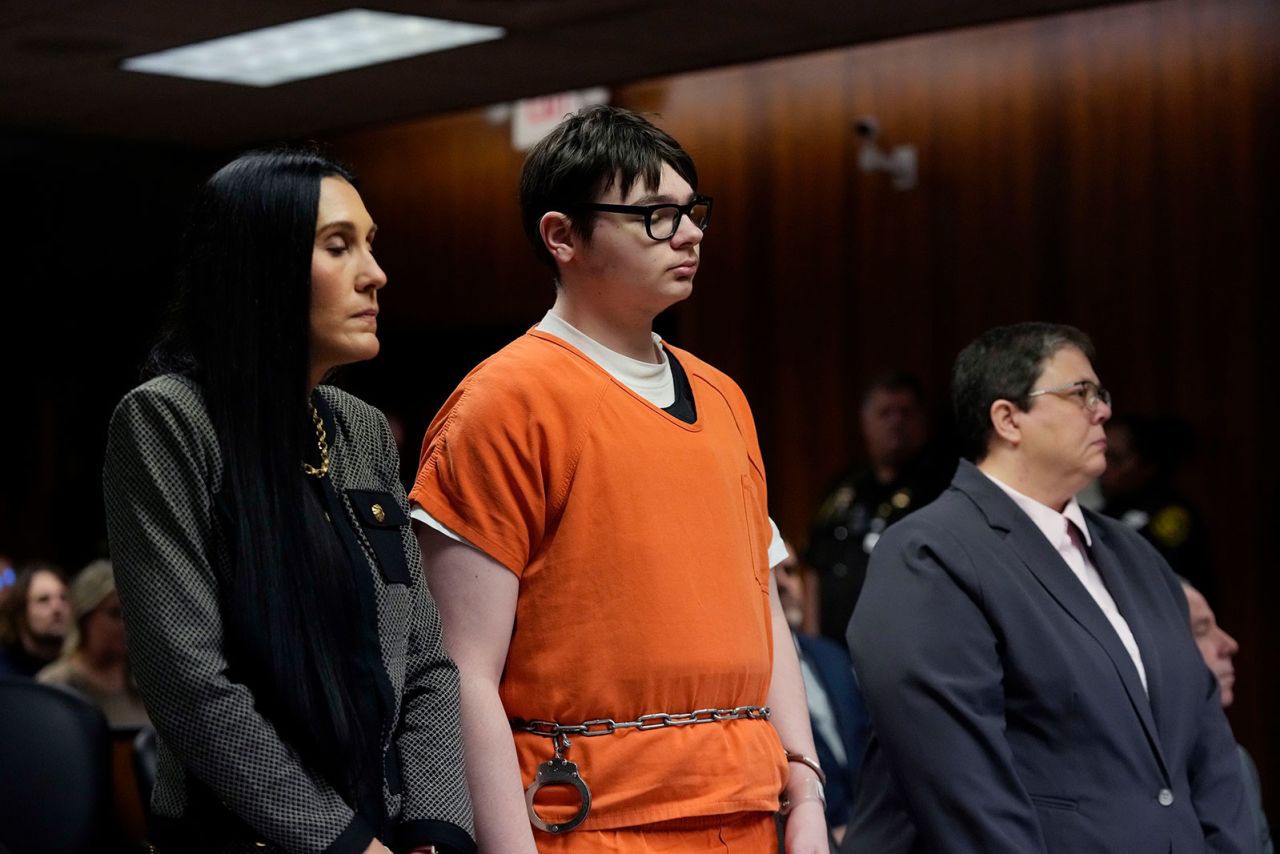 Ethan Crumbley stands with his attorneys Paulette Loftin, left, and Amy Hopp, on December 8, 2023, in Pontiac, Michigan.