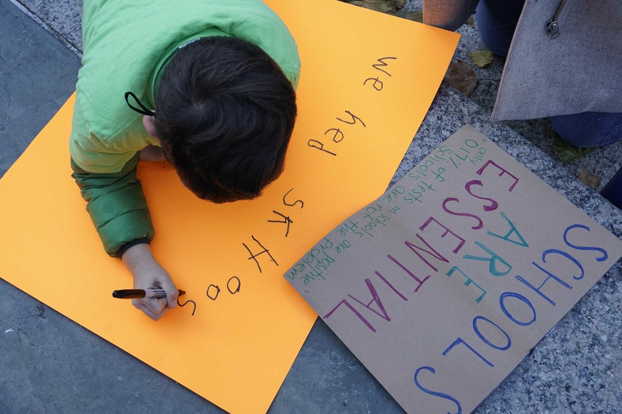 Parents and students demonstrate during a rally to call on New York Mayor Bill de Blasio to keep schools open in New York, on Saturday, November 14.