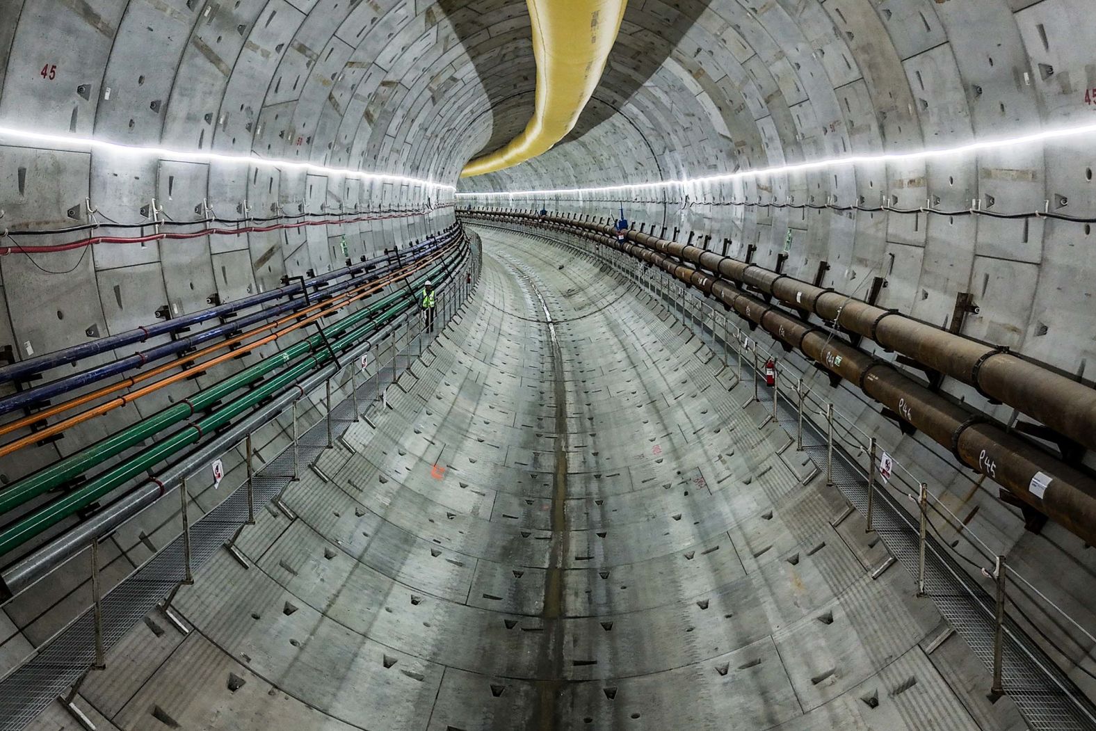 A construction worker makes his way along a track-level walkway in a metro tunnel built beneath the Panama Canal in Arraiján, Panama, on Tuesday, September 23.