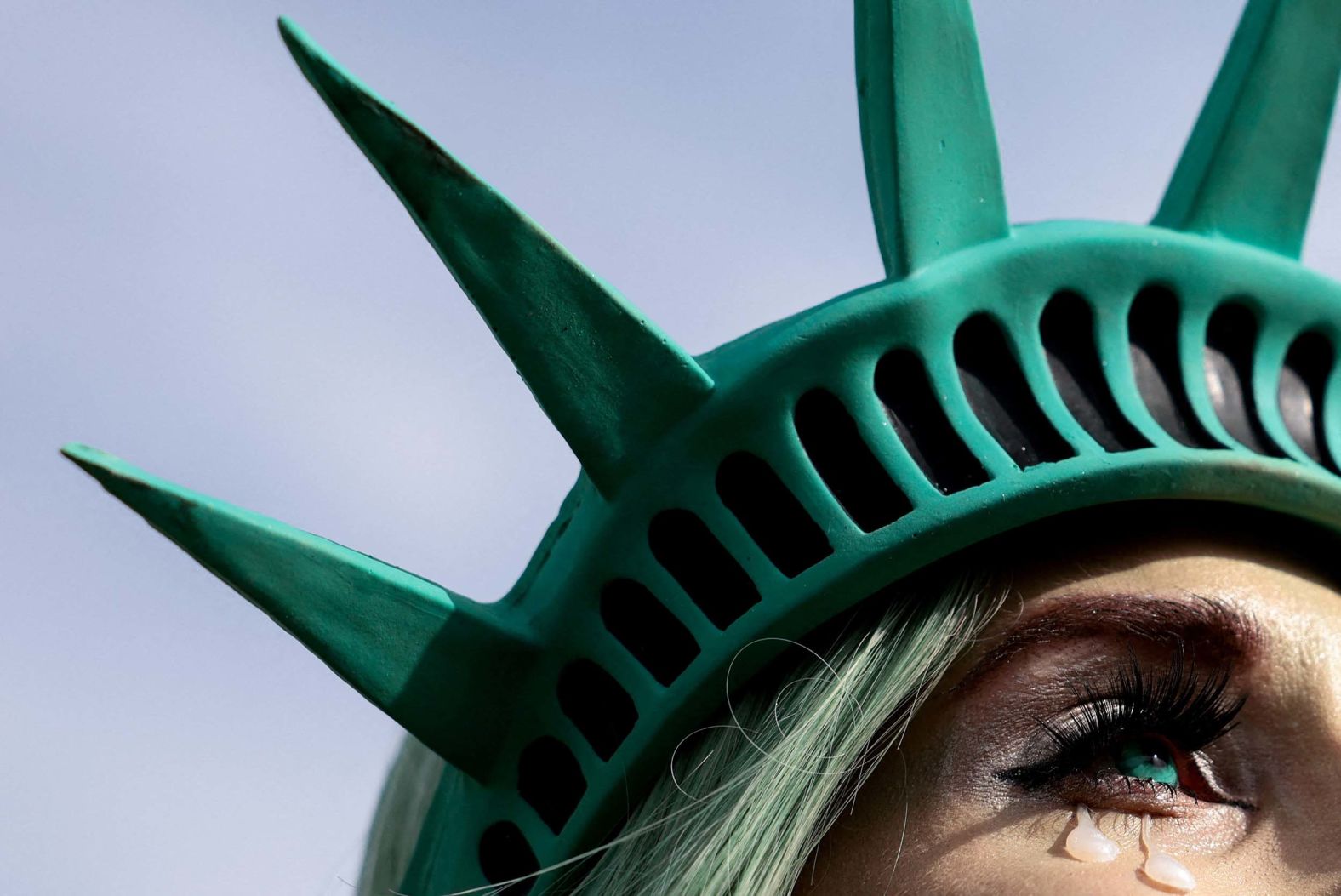 A woman wearing a Statue of Liberty-style headpiece attends a protest in Washington, DC, on Wednesday, November 5. The protest marked one year since Donald Trump was elected president a second time.