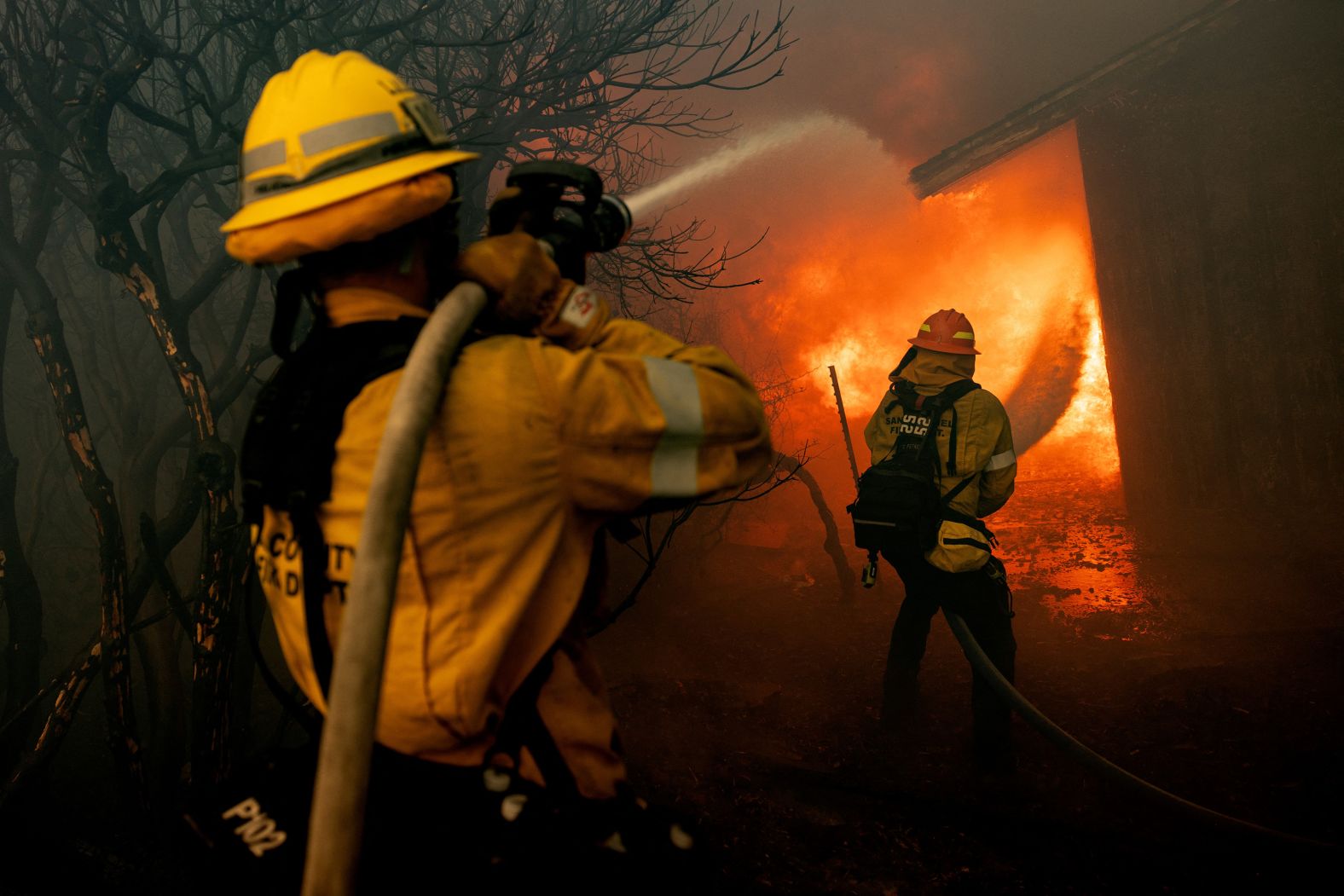 Firefighters try to control the spread of the Mountain Fire as it burns a structure in Camarillo, California, on Wednesday, November 6. The wildfire, which began Wednesday morning, burned into neighborhoods, set homes on fire and prompted authorities to <a href="index.php?page=&url=https%3A%2F%2Fwww.cnn.com%2Fweather%2Flive-news%2Fventura-county-southern-california-wildfire-11-07-24%23cm37i7wep00233b6mhzm6c74a">send more than 14,000 evacuation notices</a> as it spread to thousands of acres in a matter of hours.