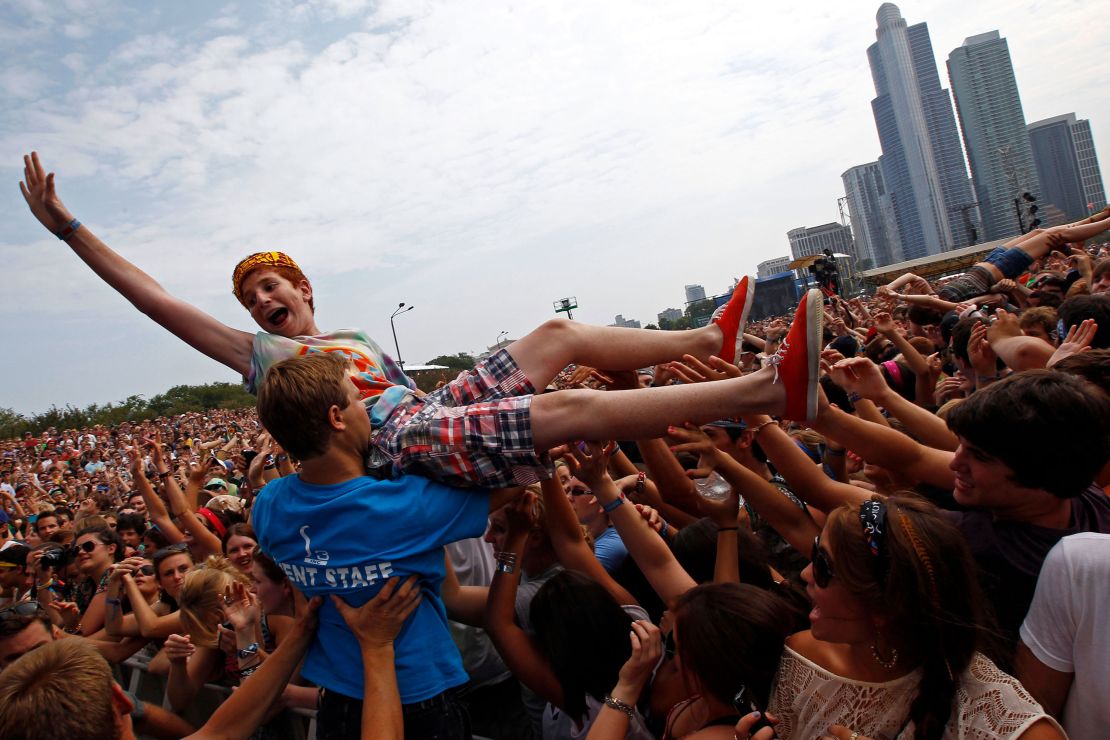 A music fan crowd surfs during a performance by Foster the People at Lollapalooza in 2011.