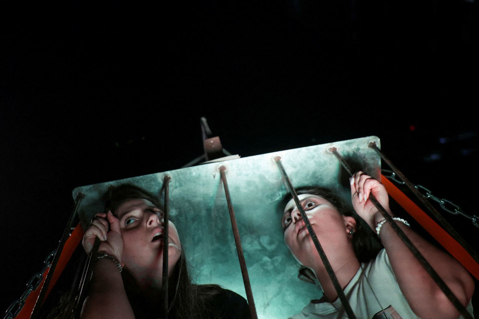 Demonstrators in Tel Aviv, Israel, sit inside a cage on Thursday, August 1, as they take part in a march calling for an immediate release of hostages being held in Gaza. The march also marked 300 days since Hamas’ deadly attack in October.