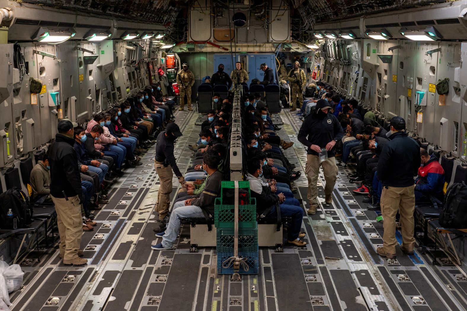 Detained migrants sit on a US Air Force plane as they await takeoff in Tucson, Arizona, on Thursday, January 23. <a href="index.php?page=&url=https%3A%2F%2Fwww.cnn.com%2F2025%2F01%2F22%2Fpolitics%2Ftrump-immigration-blitz%2Findex.html">The Trump administration has moved with lightning speed</a> to roll out the president’s immigration agenda, effectively closing off the US southern border to asylum seekers, severely limiting who’s eligible to enter the United States and laying the groundwork to swiftly deport migrants already in the country.