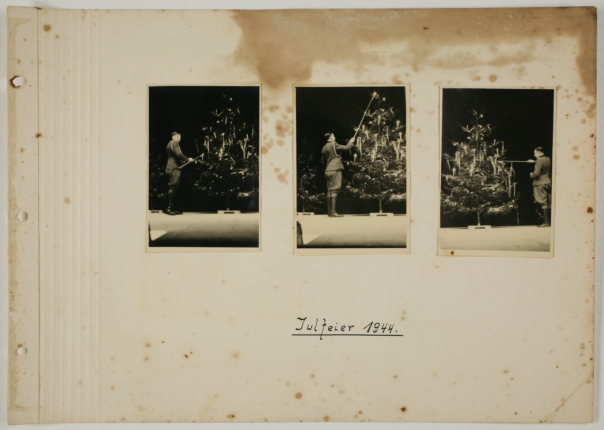 Nazi officer Karl Hoecker lights a candle on a Christmas tree only weeks before the liberation of Auschwitz. It is a page from an album that depicted activities in and around the camp.