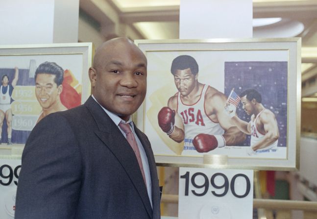 Foreman poses by a painting of himself in Minneapolis in 1990.