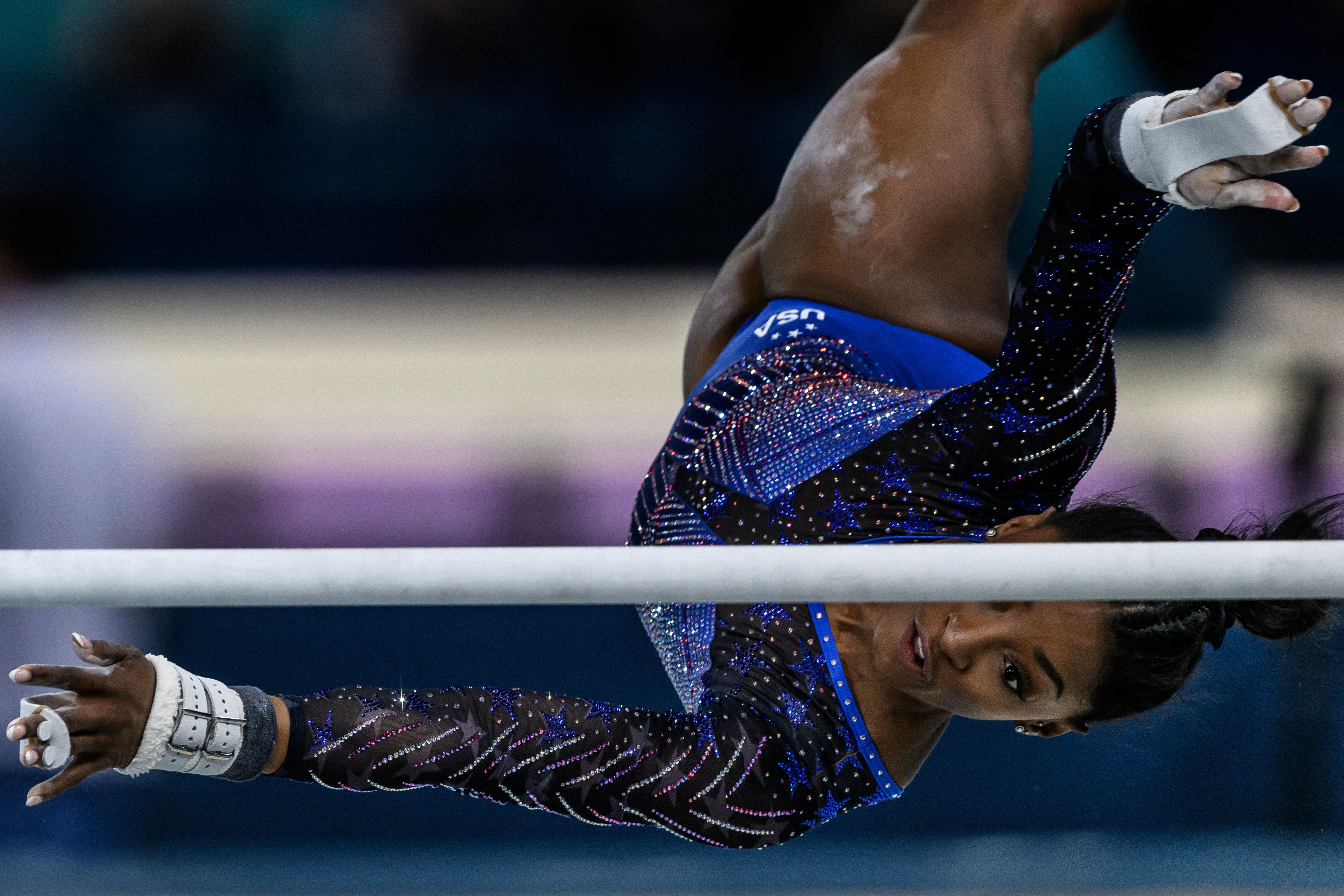 Biles twists during her uneven bars routine.