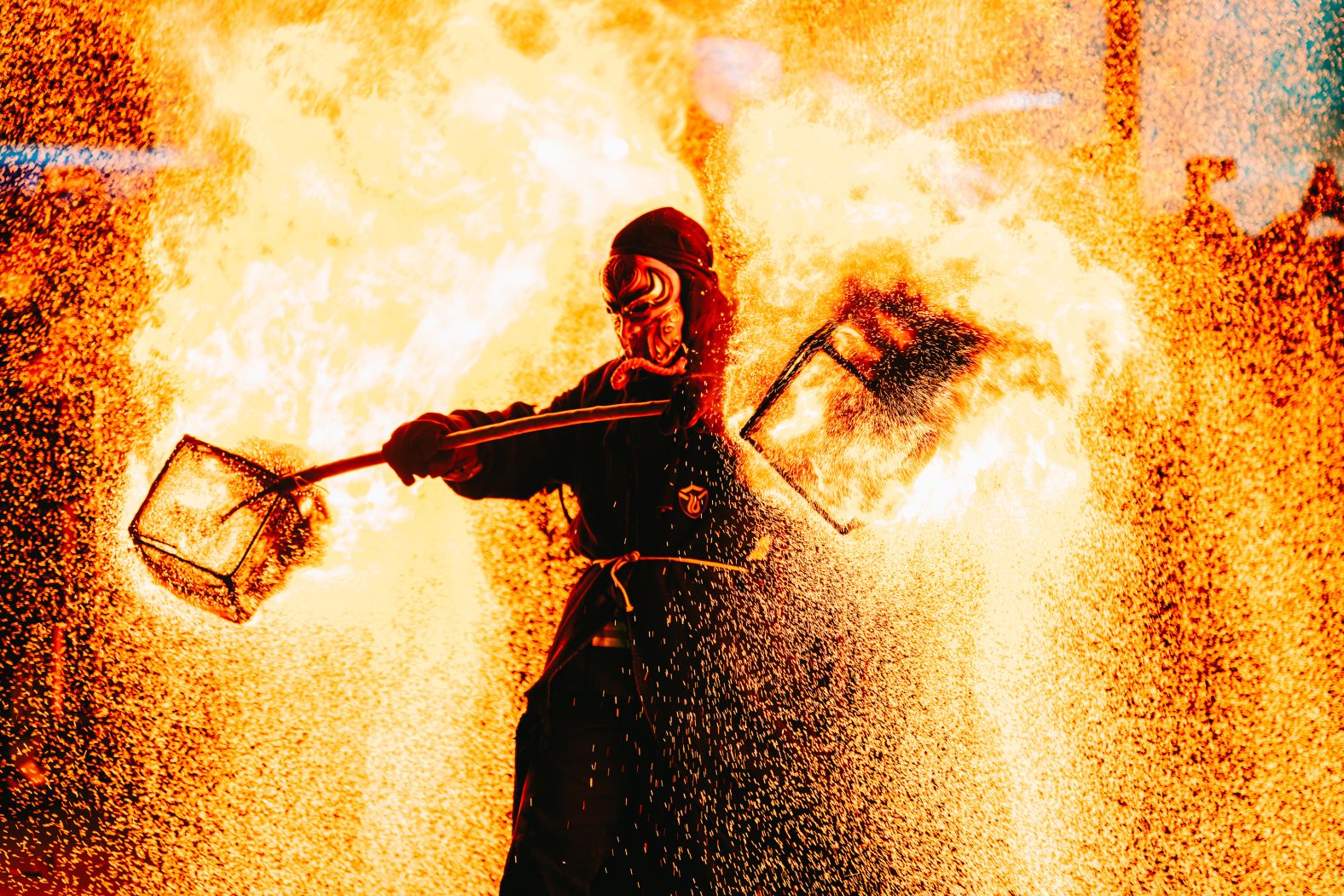 A folk artist shakes iron nets with hot charcoals to create sparks during a performance in Nanjing, China, on Saturday, December 28.