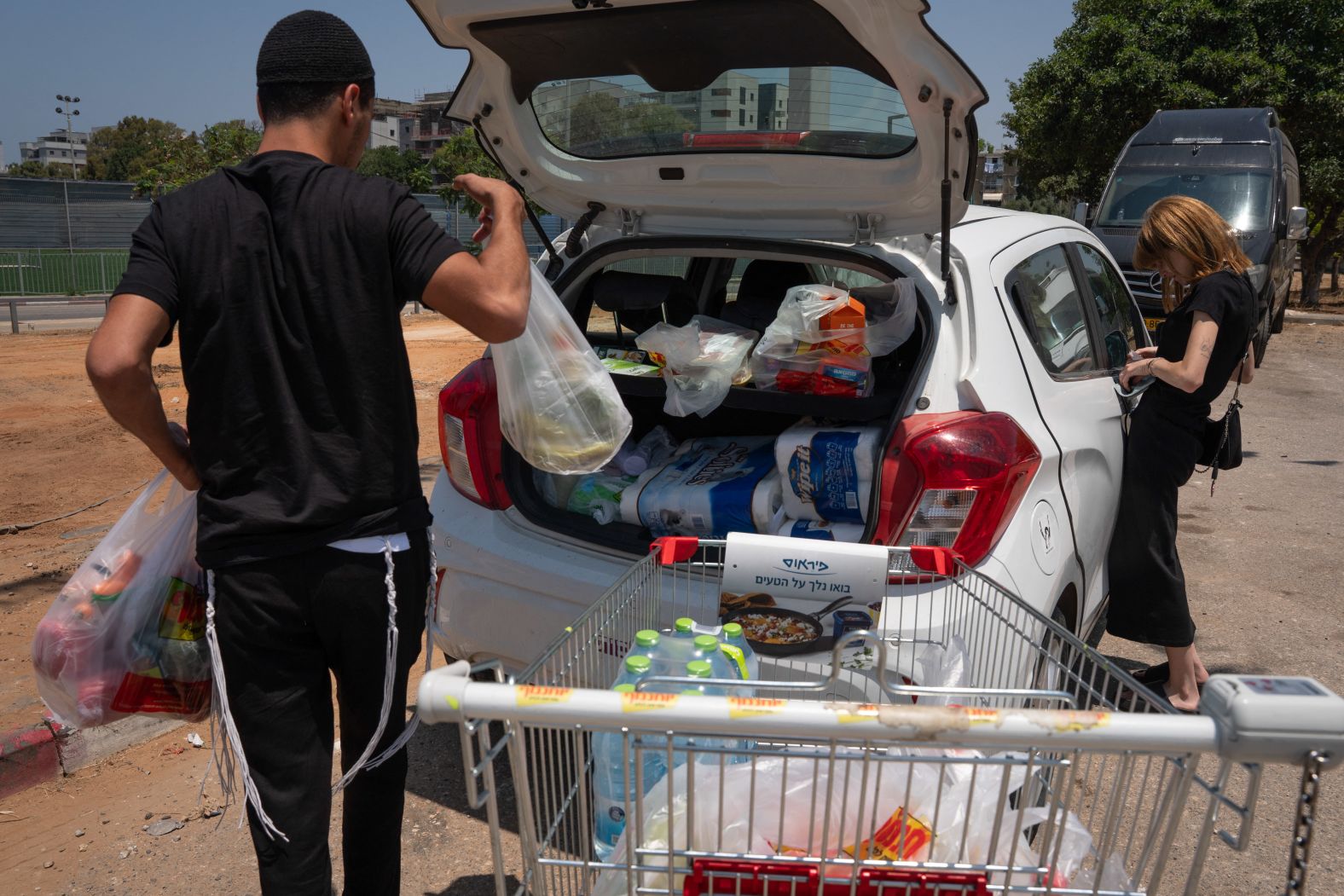 A man loads groceries in the back of his car as he stocks up with supplies in Tel Aviv on Friday.