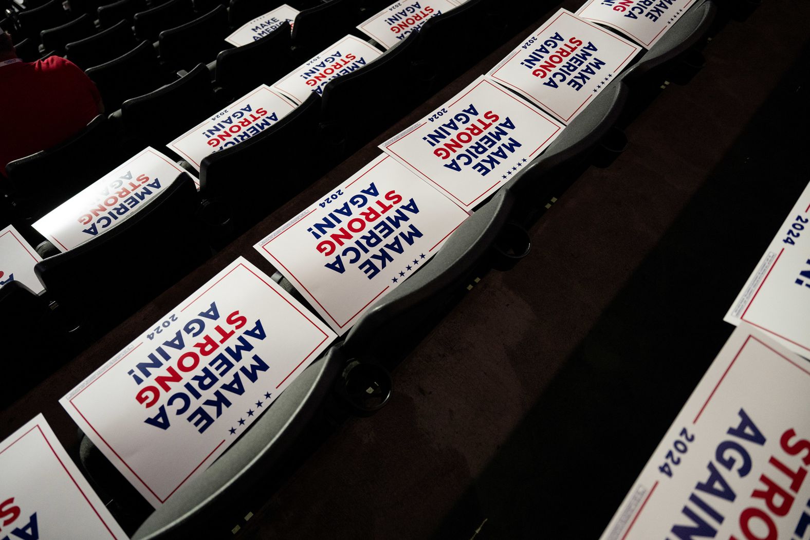 Signs are placed on seats inside the Fiserv Forum ahead of Wednesday's speeches.