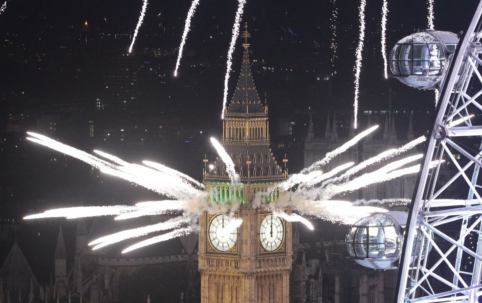 Festive fireworks light up the London skyline and Big Ben just after midnight as thousands of people lined the banks of the River Thames.