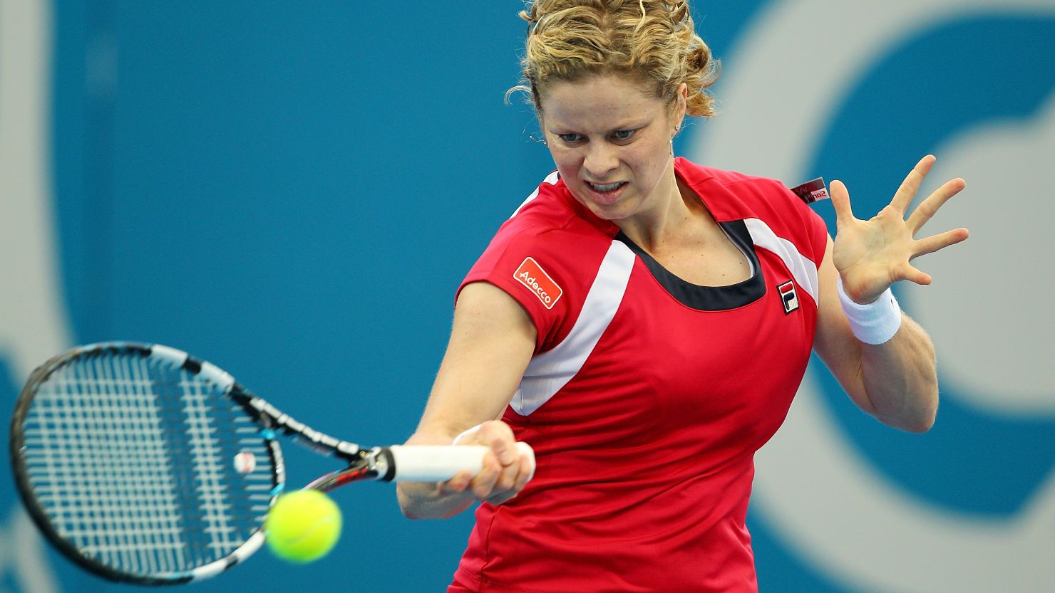 Kim Clijsters plays a return during her straight sets win over Simona Halep in Brisbane.
