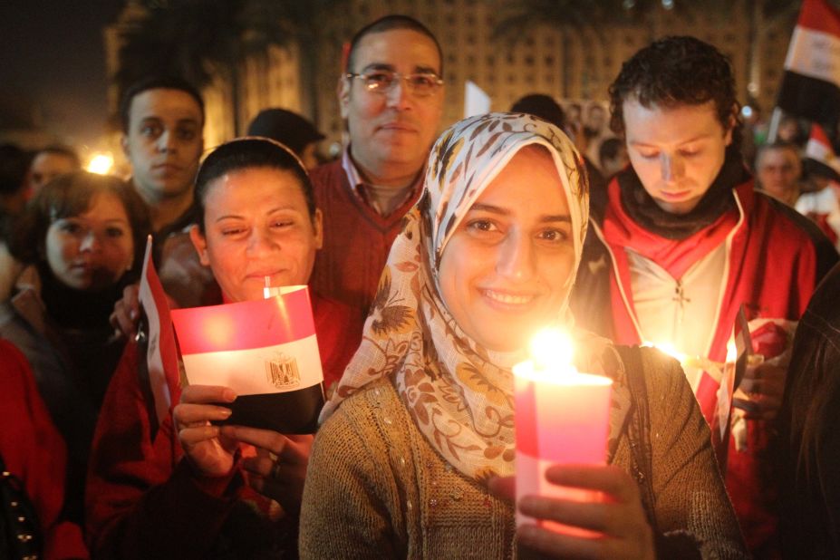 Thousands of Egyptian Muslims and Coptic Christians attend a celebration on New Year's Eve in Tahrir Square in Cairo,  as they remember those killed in the revolution that ended the long reign of President Hosni Mubarak.
