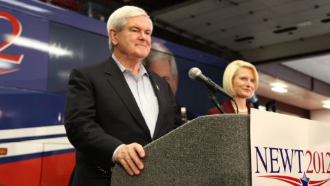 Newt Gingrich, campaigning in Iowa with his wife Callista, has been the target of negative advertising.