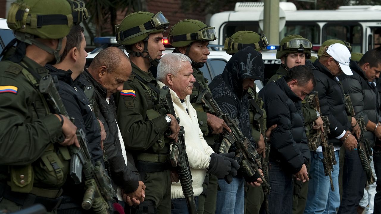 Police guard alleged members of the 'Loco Barrera' (Crazy Barrera) drug trafficking ring. The U.S. wants them extradited.