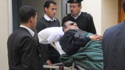 Former president Hosni Mubarak lies on a stretcher as he leaves court in Cairo on January 2.