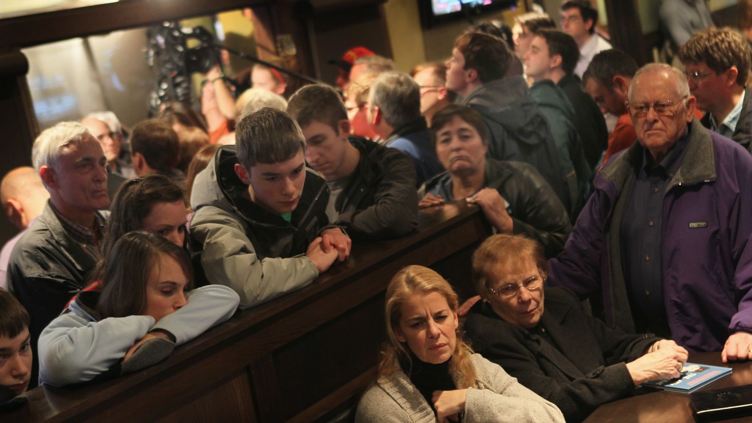 Guests in Marshalltown, Iowa watch a live C-SPAN broadcast as Rick Santorum speaks in an adjacent room at Legends Bar and Grill last week