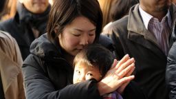 A businesswoman prays for a good business year as worshippers gather at the Kanda shrine in Tokyo on January 4, 2012.