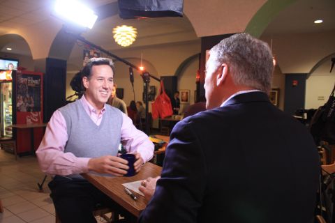 Most men can't pull off pink -- but Santorum isn't most men. Here he tones down the ensemble with a gray sweater vest to talk with CNN's John King in a diner in Cedar Rapids.