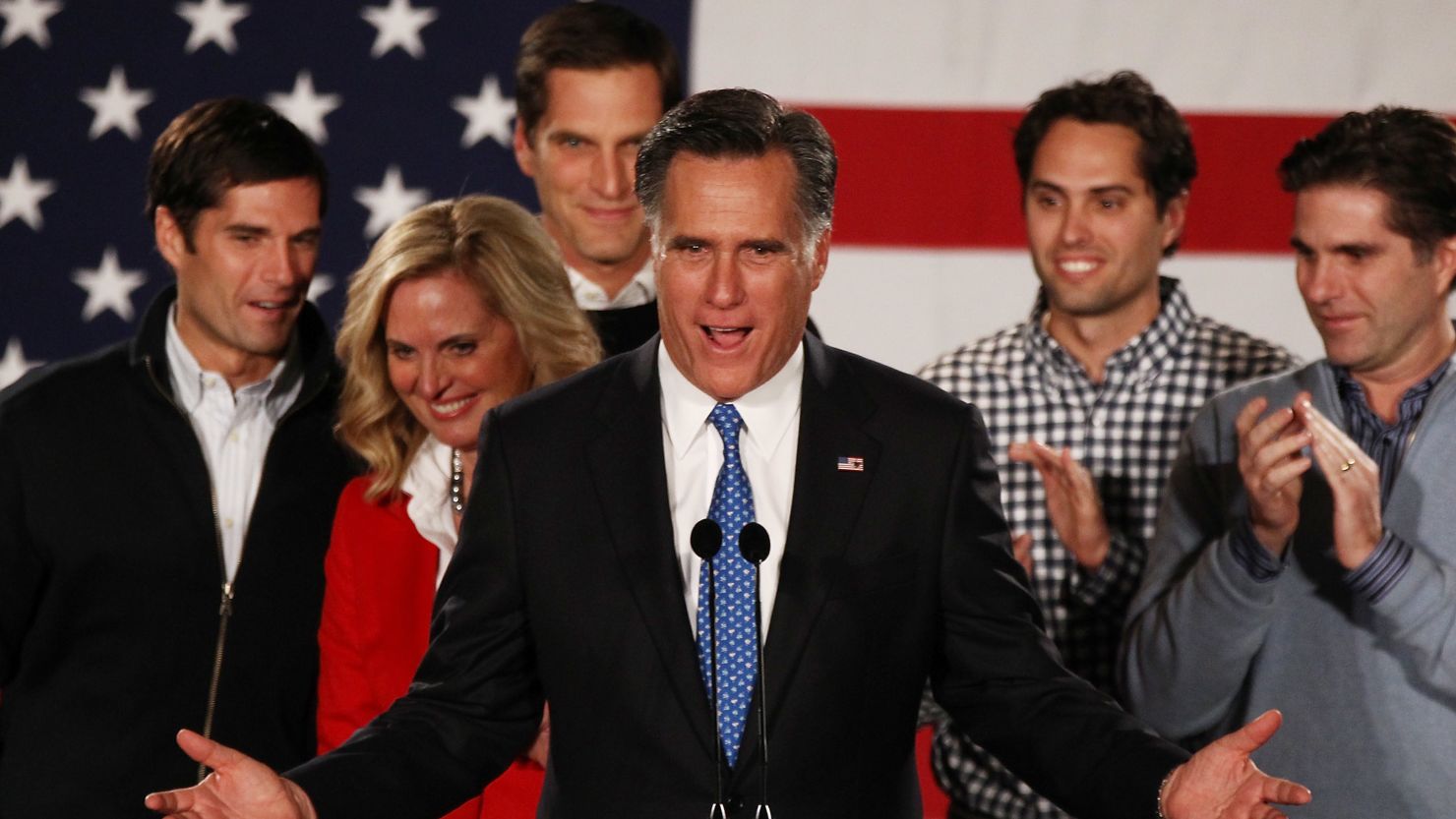 Mitt Romney speaks as his wife Ann Romney and their sons look on after the very close finish in the Iowa caucus.