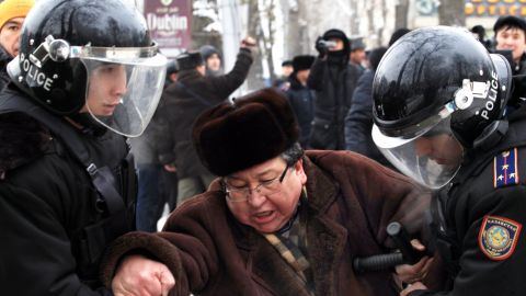 Kazakh riot policemen detain an opposition supporter during a rally in Almaty on December 17, 2011.