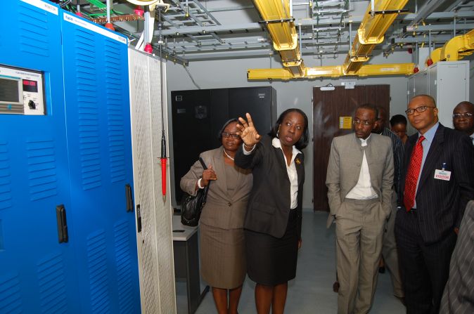 The governor of Central Bank of Nigeria, Lamido Sanusi (middle), tours the Lagos landing station. 