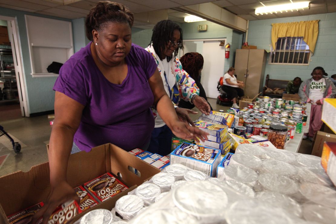 Andono Bryant sorts food at an Atlanta co-op, while her husband cooks for the well-to-do.