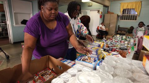 Andono Bryant sorts food at an Atlanta co-op, while her husband cooks for the well-to-do.