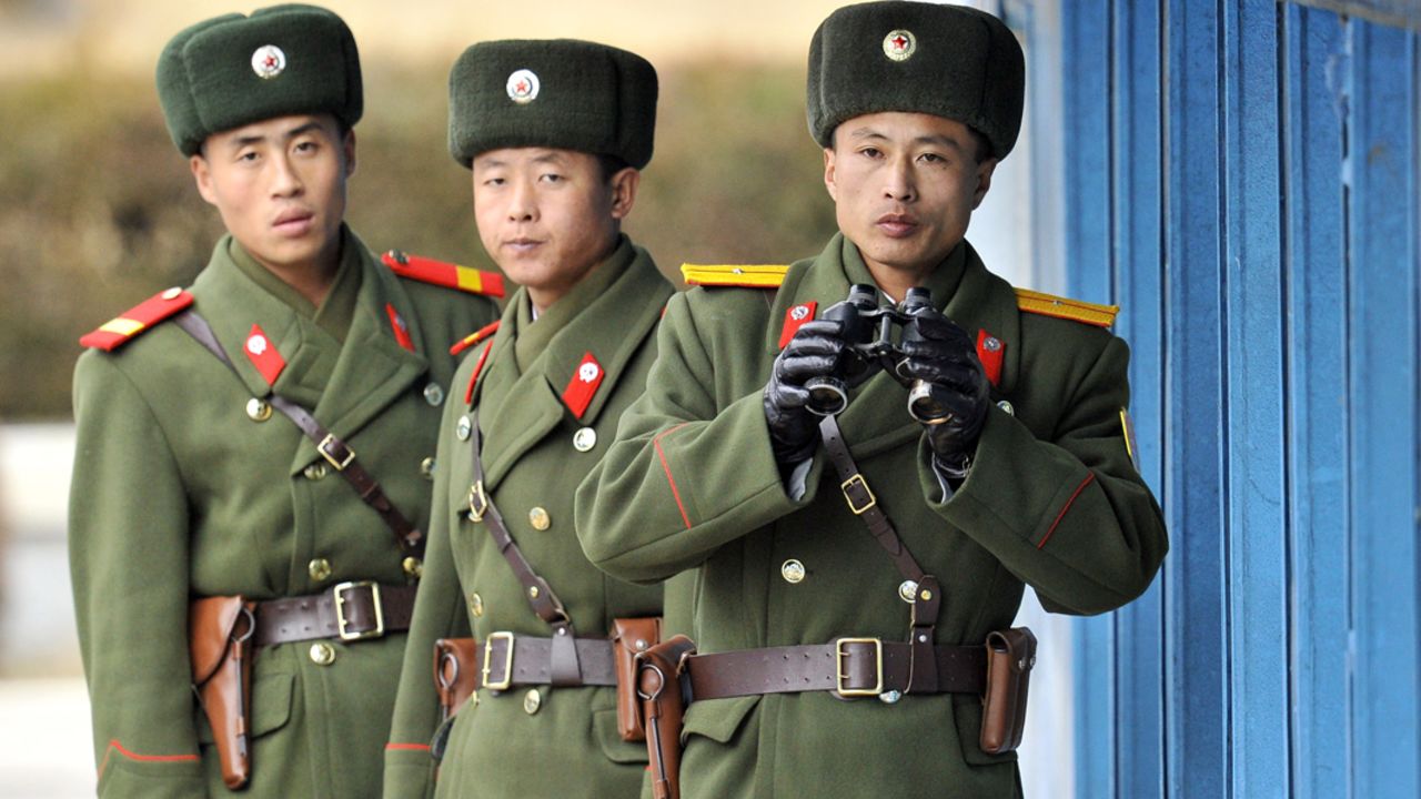North Korean soldiers look at South Korea across the Korean Demilitarized Zone (DMZ), on December 22, 2011.