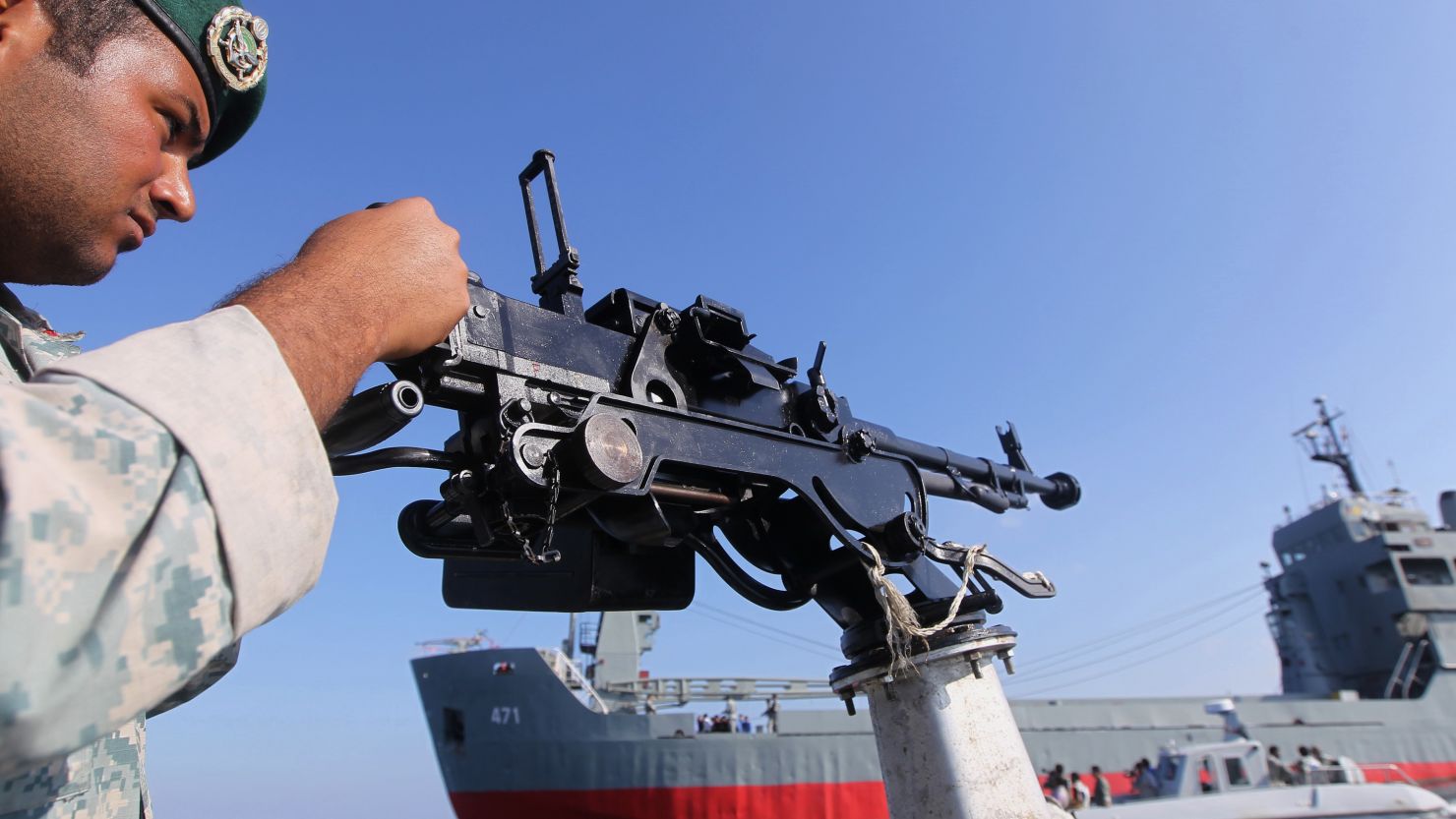 A soldier stands guard on a military speed boat during Iran's navy exercises in the Strait of Hormuz on December 28, 2011.