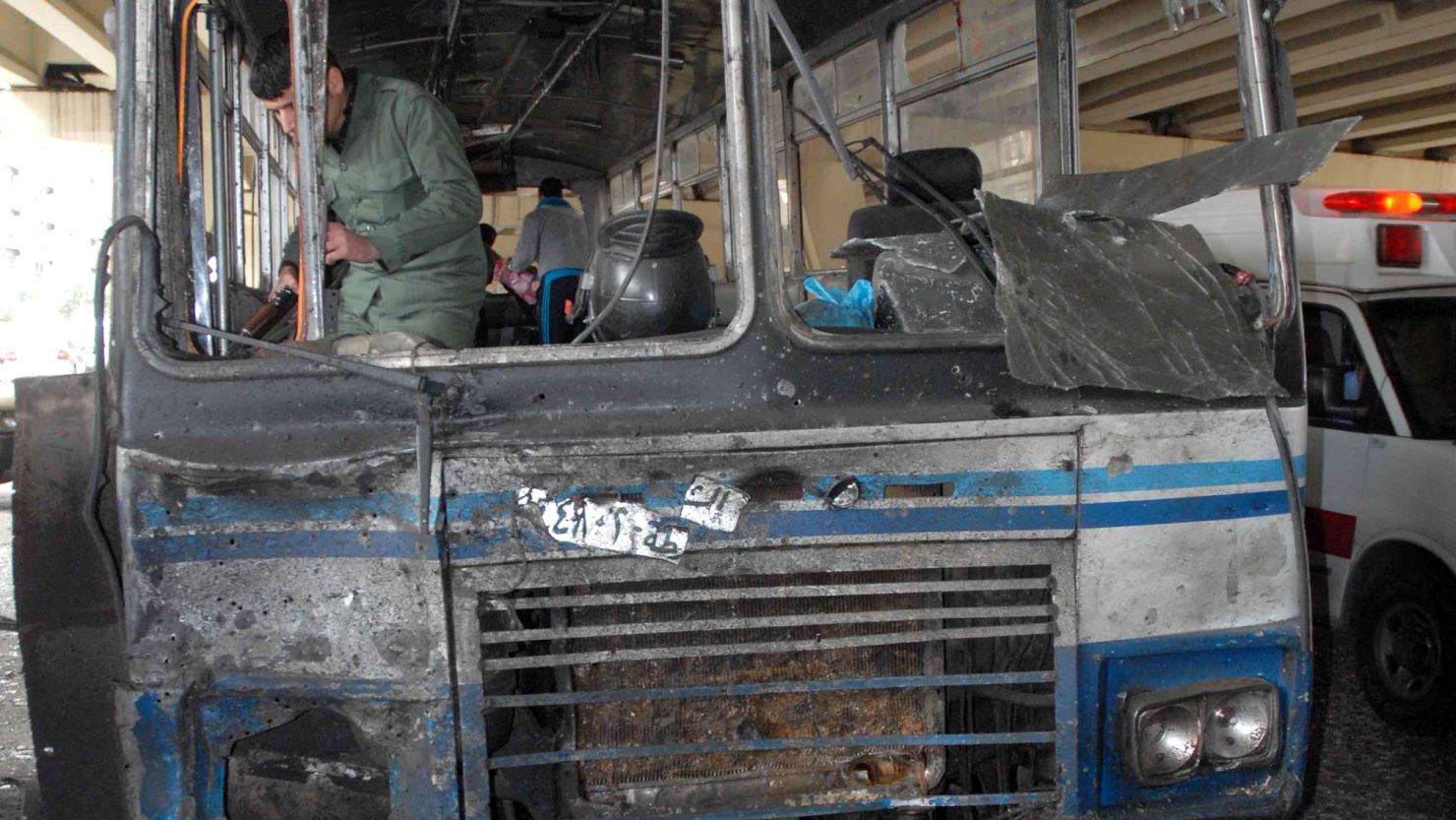 A photo released by the Syrian News Agency shows a damaged bus at the site of Friday's suicide bombing in Damascus.