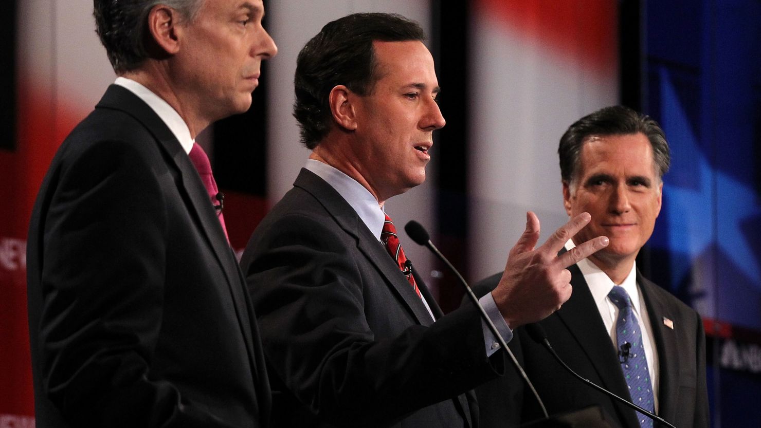 Jon Huntsman, left, Rick Santorum and Mitt Romney participate in Sunday's debate in New Hampshire.