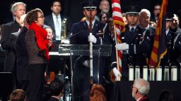 Rep. Gabrielle Giffords leads the crowd in the pledge of allegiance during a vigil on Sunday, January 8, 2012, in Tucson, Arizona, marking one year since a shooting rampage left her and 12 others wounded and six people dead.