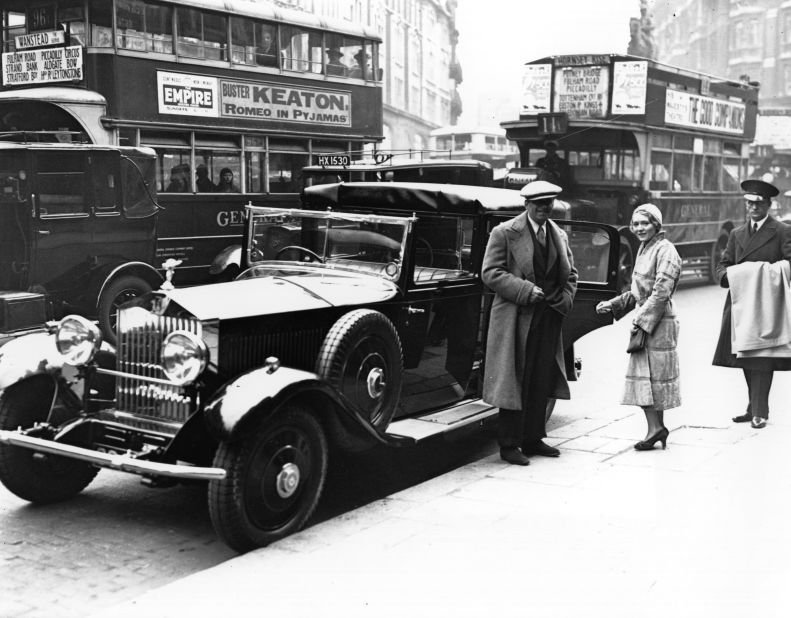 The ultimate in glamor: U.S. acting couple Douglas Fairbanks Jr. and Mary Pickford stand beside their chauffeur-driven Rolls-Royce in London in 1931.