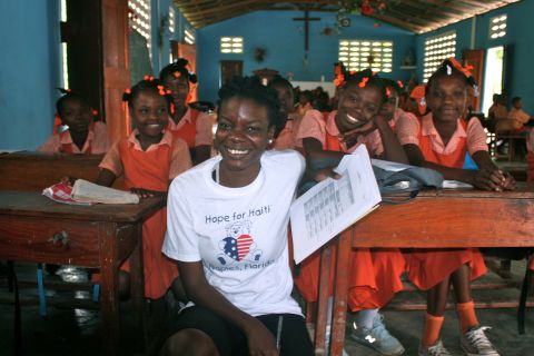 Jessica Jean-Francois, program manager for Hope for Haiti, meets students at the Notre Dame de Cherettes Primary School in Cherettes. Hope for Haiti supports 40 schools and 400 teachers in Haiti.