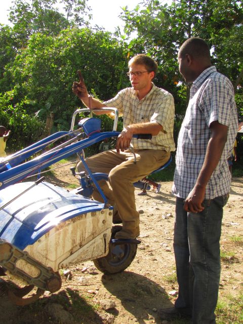 Agronomists Jamie Rhoads and Gregory Antenor test MFK's new tractor. MFK trains and educates Haitian farmers on how to plant using modern methods, treat seeds to avoid toxins and use new farming machinery.