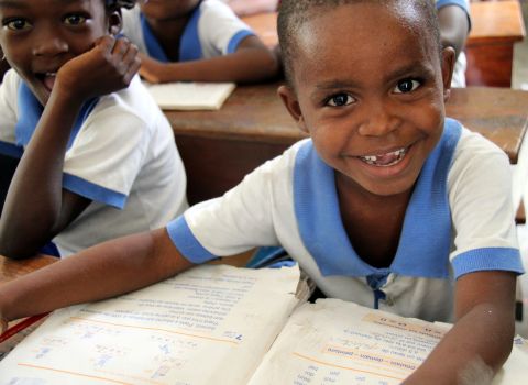 Young students sit in class at a school sponsored by Hope for Haiti. This school year, Hope for Haiti provided books to students through the Book Share Project.