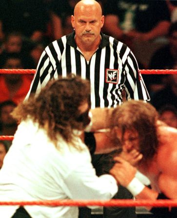 One-time Minnesota governor, former professional wrestler and guest referee Jesse Ventura, center, watches the action during the World Wrestling Federation SummerSlam in 1999 in Minneapolis.