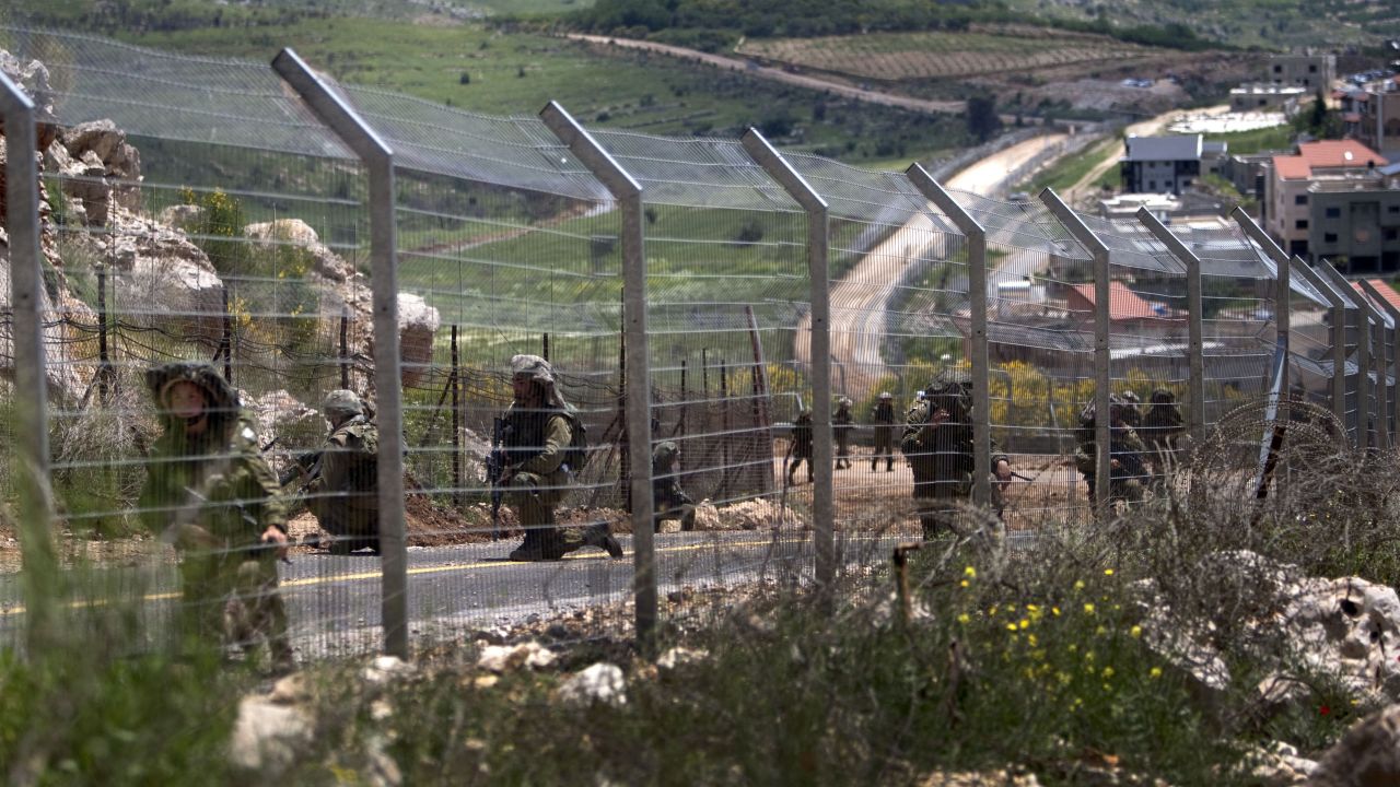 Israeli soldiers patrol along the border fence between the Israeli-annexed Golan Heights and Syria on May 20, 2011. 