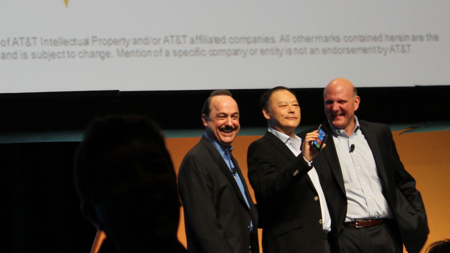 AT&T CEO Ralph de la Vega, from left, HTC CEO Peter Chou and Microsoft CEO Steve Ballmer promote Windows Phone products.