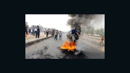A boy jumping over a burning tyre on a street in Nigeria where protests against the removal of fuel subsidy have raged since 3 January. 