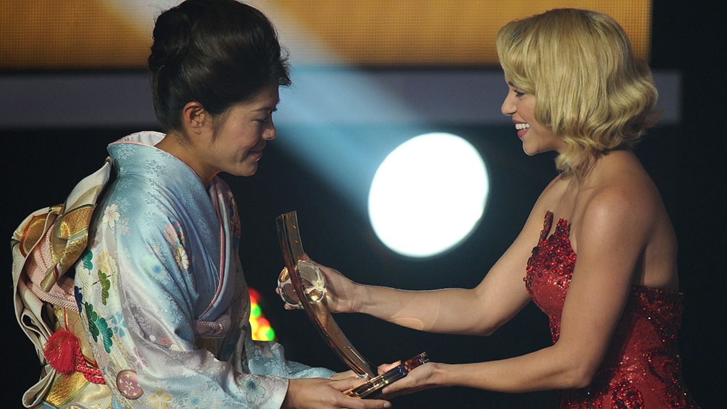 Homare Sawa (left) receives the FIFA Women's World Player of the Year award from Colombian singer Shakira.
